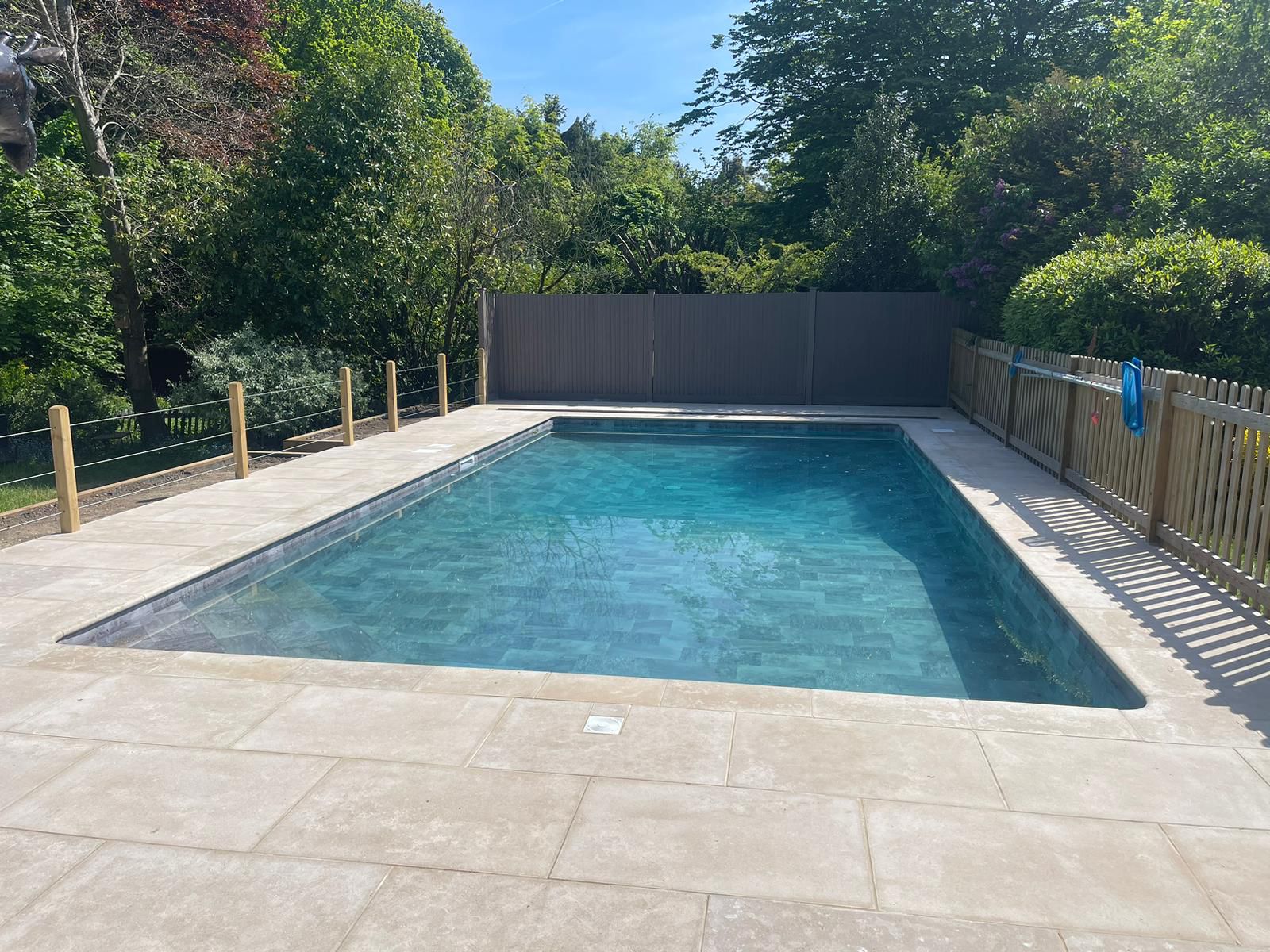 Light grey patio with pool